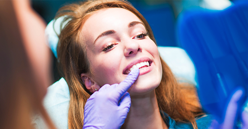Woman getting her teeth checked - dentist in Manhattan, KS