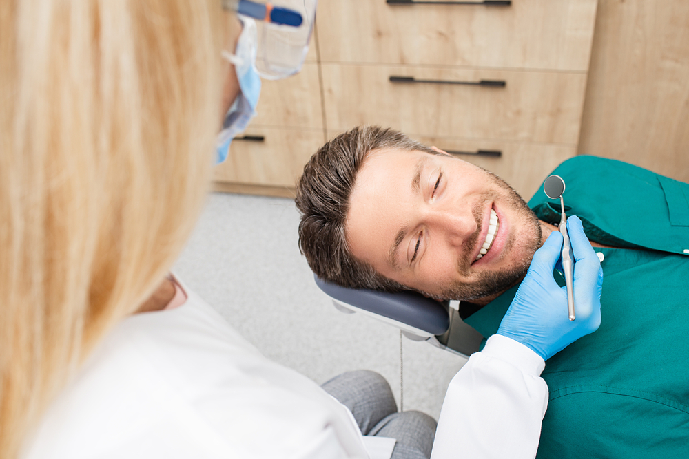 young man mid dental exam