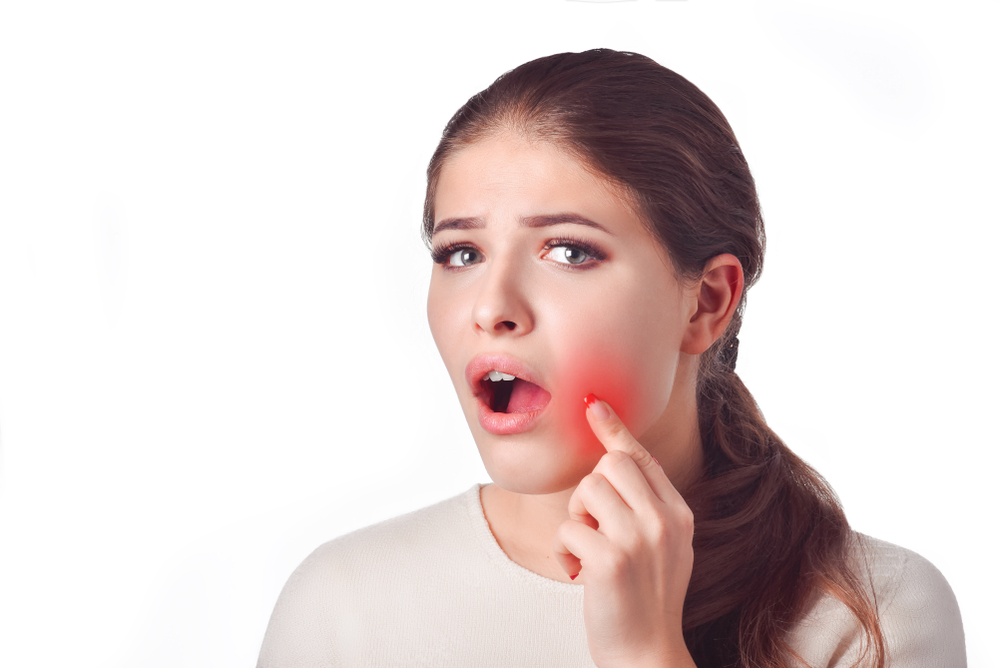 young woman experiences dental or jaw pain