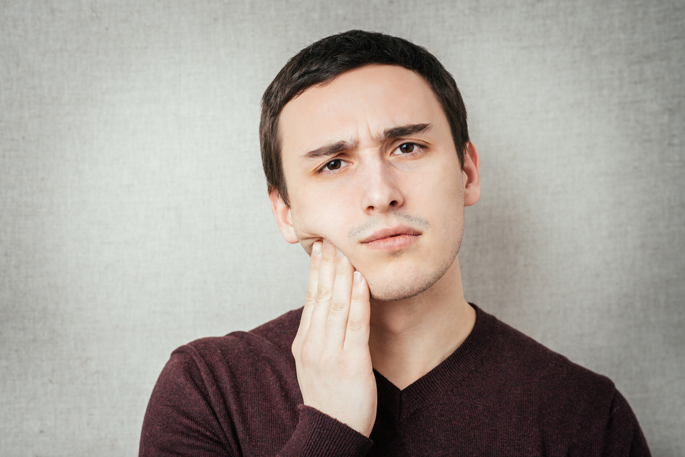 young man has a toothache
