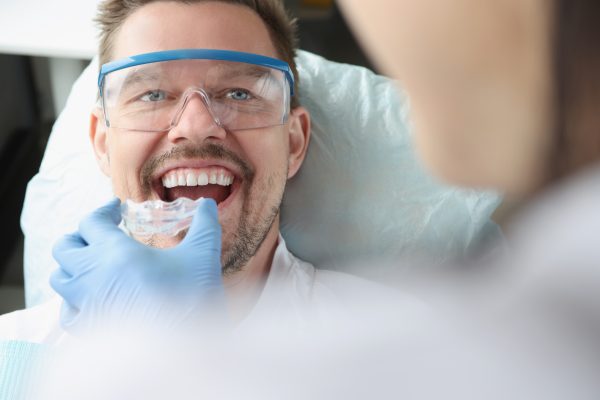 man getting mouthguard at dentist